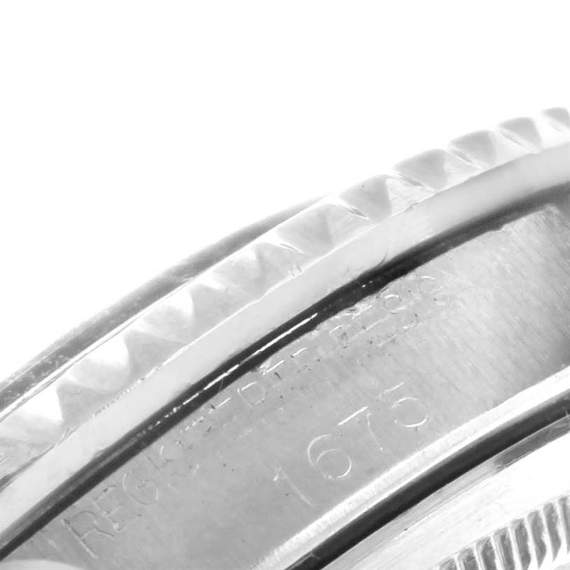 The image shows a close-up of the side view of the bezel and engraved serial number of the Rolex Vintage Collection 1675 Men's Stainless Steel Black Dial 1675 Men's Stainless Steel Black Dial model.