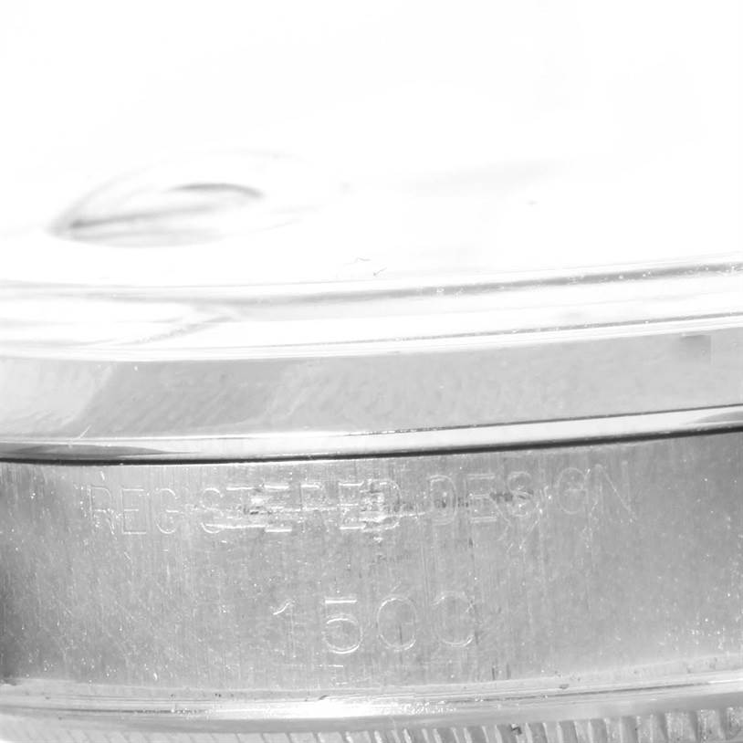 This image shows a close-up side view of the bezel and the edge of the caseback, with its etchings for the Vintage Collection model by Rolex.