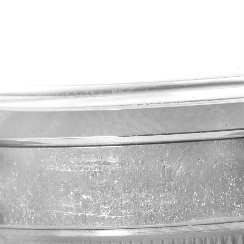 The image shows a close-up of the side casing of a Rolex Vintage Collection 1500 Men's Stainless Steel Silver Dial 1500 Men's Stainless Steel Silver Dial model watch, focusing on the engraved serial number and part of the bezel.