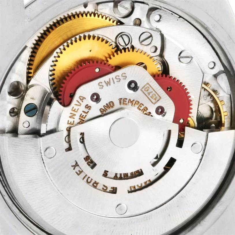 The image shows a close-up of the internal gears and parts of a Vintage Collection Rolex watch.