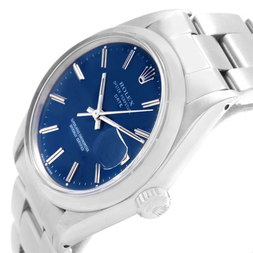 The Vintage Collection Rolex watch is shown at an angled side view, highlighting its blue dial, metal bracelet, and crown.