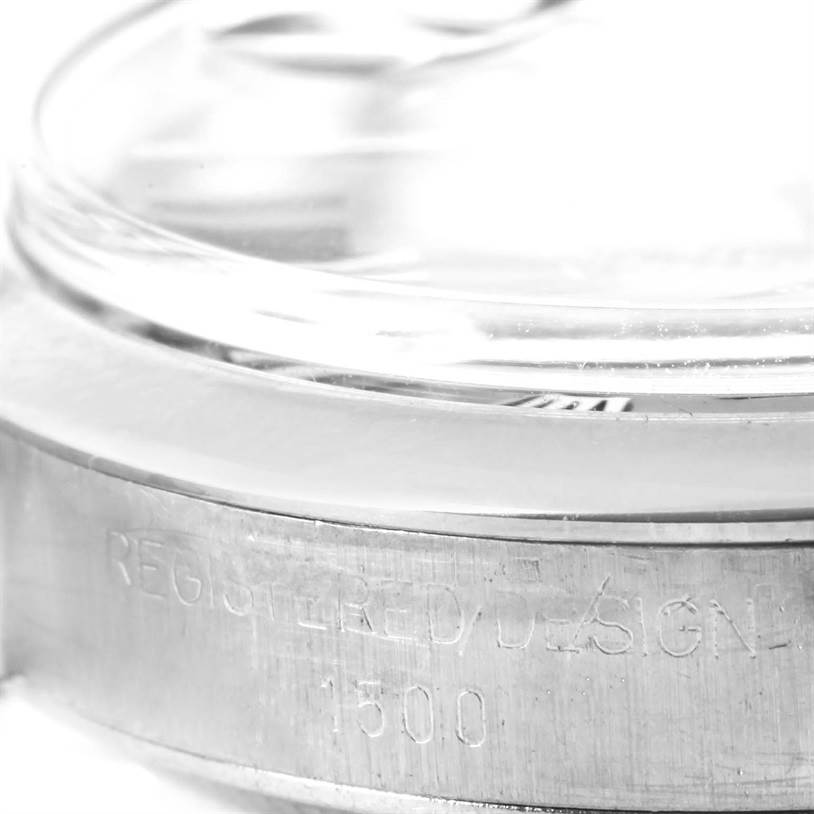 This is a close-up angle of the side view showing the bezel and part of the case of a Rolex Vintage Collection 1500 Men's Stainless Steel Blue Dial 1500 Men's Stainless Steel Blue Dial model watch.