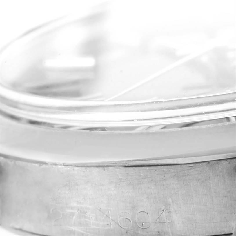 This close-up image shows the side of the bezel and case of a Rolex Vintage Collection 1500 Men's Stainless Steel Blue Dial 1500 Men's Stainless Steel Blue Dial model, with part of the serial number visible.