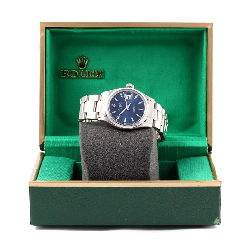 The angle shows a front view of a Rolex Vintage Collection 1500 Men's Stainless Steel Blue Dial 1500 Men's Stainless Steel Blue Dial watch in an open green and gold box.