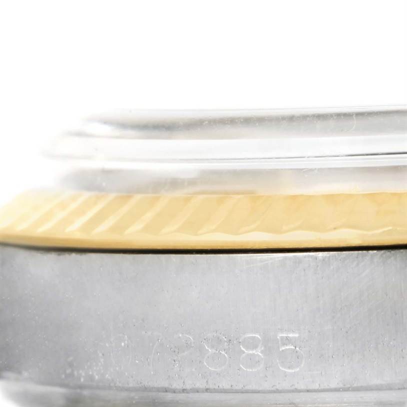 This close-up image shows the bezel, crystal, and part of the case with the serial number of a Rolex Vintage Collection 1601 Men's Stainless Steel Silver Dial 1601 Men's Stainless Steel Silver Dial model watch.