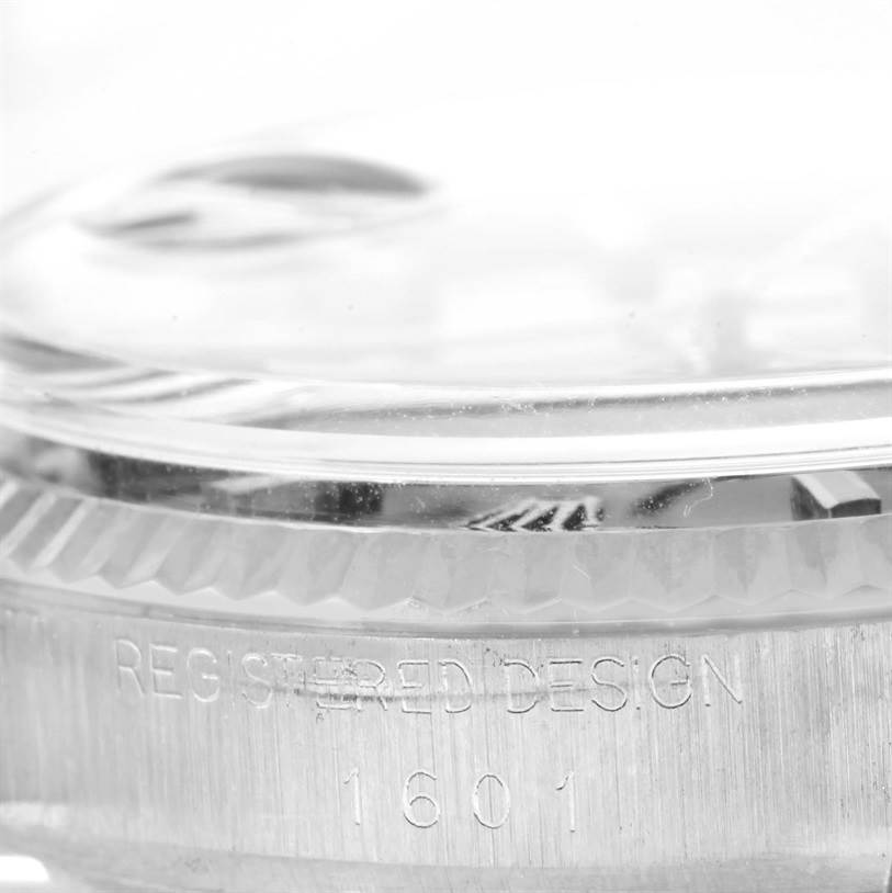 This close-up image of the Rolex Vintage Collection 1601 Men's Stainless Steel Blue Dial 1601 Men's Stainless Steel Blue Dial model showcases the side view of the watch, highlighting the case and the “REGISTERED DESIGN 1601” engraving.