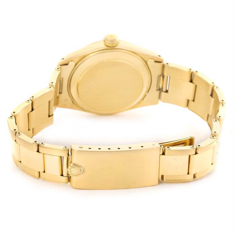 This image shows the back case, crown, and bracelet of the Rolex Vintage Collection 6627 Yellow Gold Champagne Dial 6627 Yellow Gold Champagne Dial model watch from a rear angle.