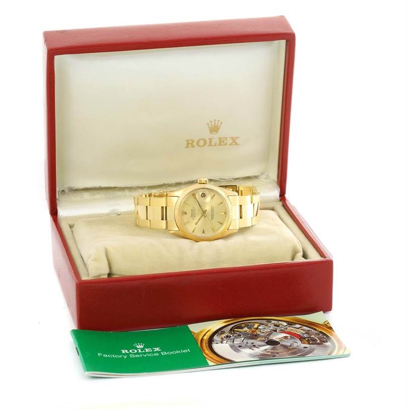 The Rolex Vintage Collection 6627 Yellow Gold Champagne Dial 6627 Yellow Gold Champagne Dial watch is shown at an angle inside its box, with a factory service booklet nearby.
