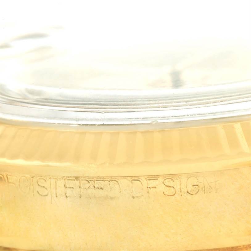 The image shows a close-up angle of the gold bezel and part of the crystal of the Rolex Vintage Collection 6627 Yellow Gold Champagne Dial 6627 Yellow Gold Champagne Dial model watch.