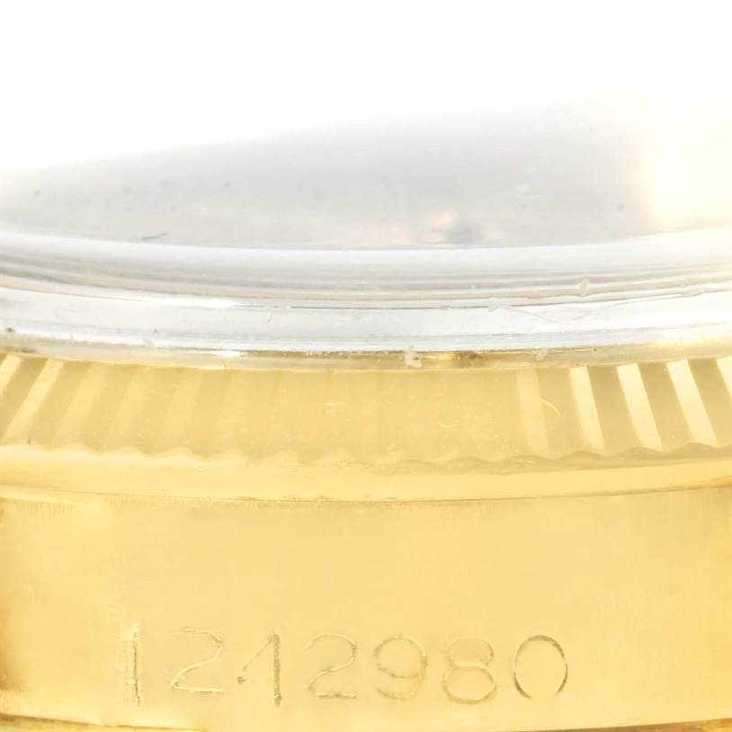 This image shows a close-up of the serial number and fluted bezel on the Rolex Vintage Collection 6627 Yellow Gold Champagne Dial 6627 Yellow Gold Champagne Dial model watch.