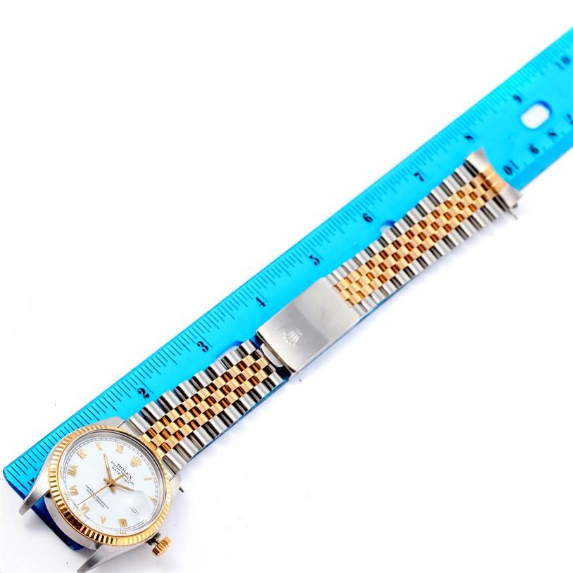 The image shows a side angle of a Vintage Collection Rolex watch, highlighting the face, crown, and bracelet with a ruler beside it.