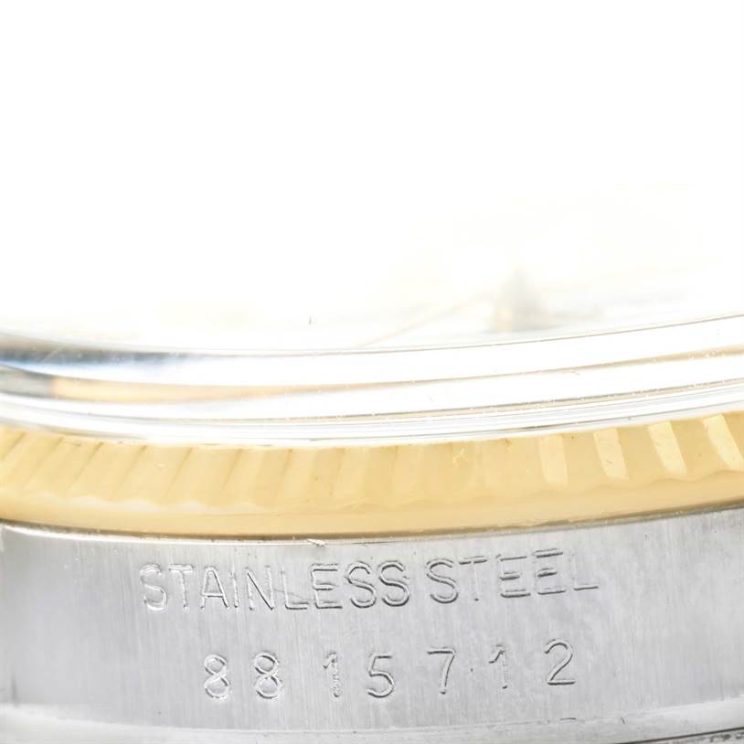 This close-up image shows part of the case and engraved serial number of a Vintage Collection model by Rolex.