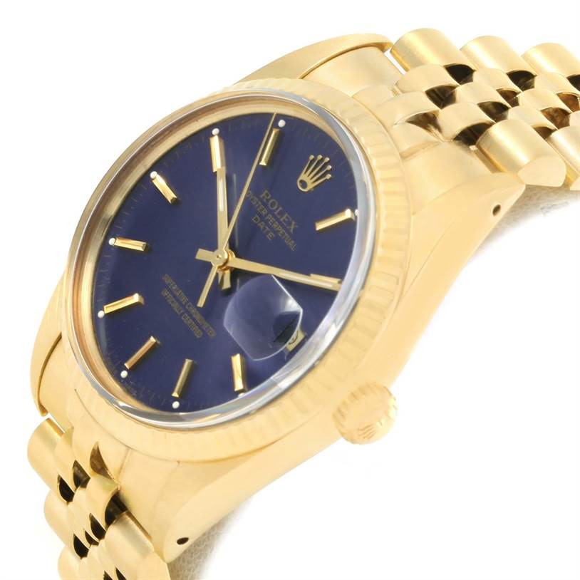 This is a side-angle view of a Rolex Vintage Collection 15037 Men's Yellow Gold Blue Dial 15037 Men's Yellow Gold Blue Dial watch, showcasing the blue dial, gold case, crown, and part of the gold bracelet.