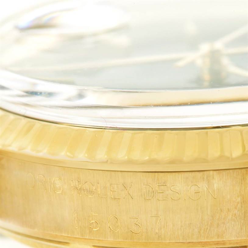 This close-up shows the side of the Rolex Vintage Collection 15037 Men's Yellow Gold Blue Dial 15037 Men's Yellow Gold Blue Dial watch, highlighting the model number and "Orig Rolex Design" engraving.