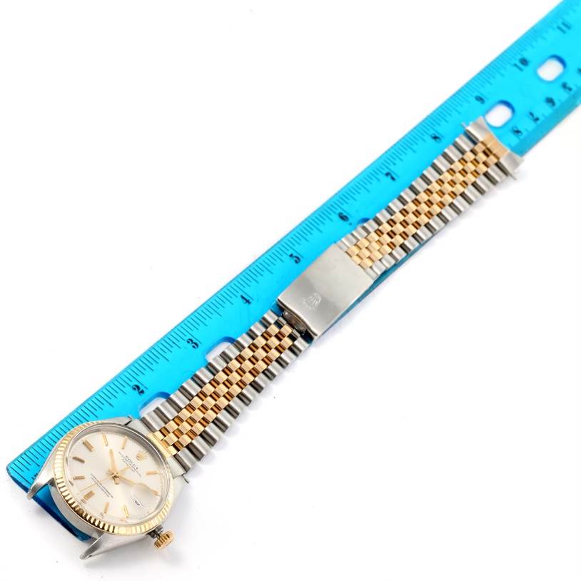 The image shows a Rolex Vintage Collection 1601 Men's Stainless Steel Silver Dial 1601 Men's Stainless Steel Silver Dial watch with a stainless steel and gold jubilee bracelet next to a blue ruler for scale.