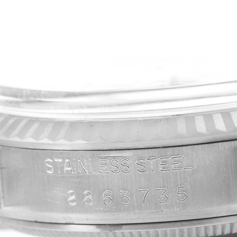 The image shows a close-up of the watch case back, displaying "STAINLESS STEEL" and a serial number on a Vintage Collection model by Rolex.