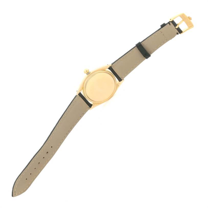 The image shows a Vintage Collection Rolex watch from a rear angle, highlighting its case back, leather strap, and buckle.