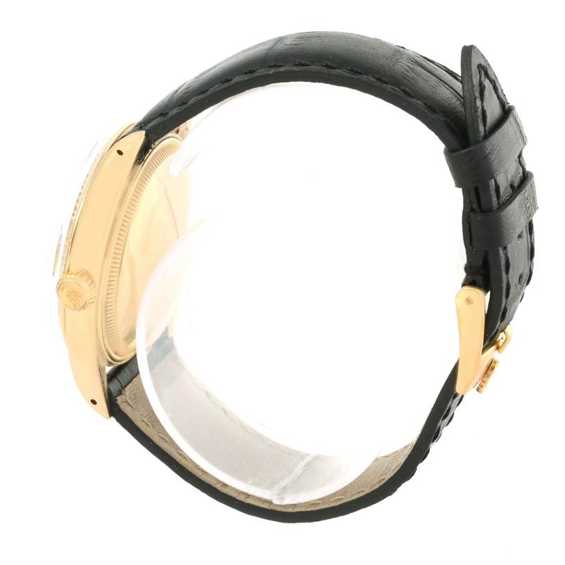 The image shows a side view of the Rolex Vintage Collection 1503 Men's Yellow Gold Champagne Dial 1503 Men's Yellow Gold Champagne Dial watch, focusing on the crown, gold case, and black leather strap with a buckle.