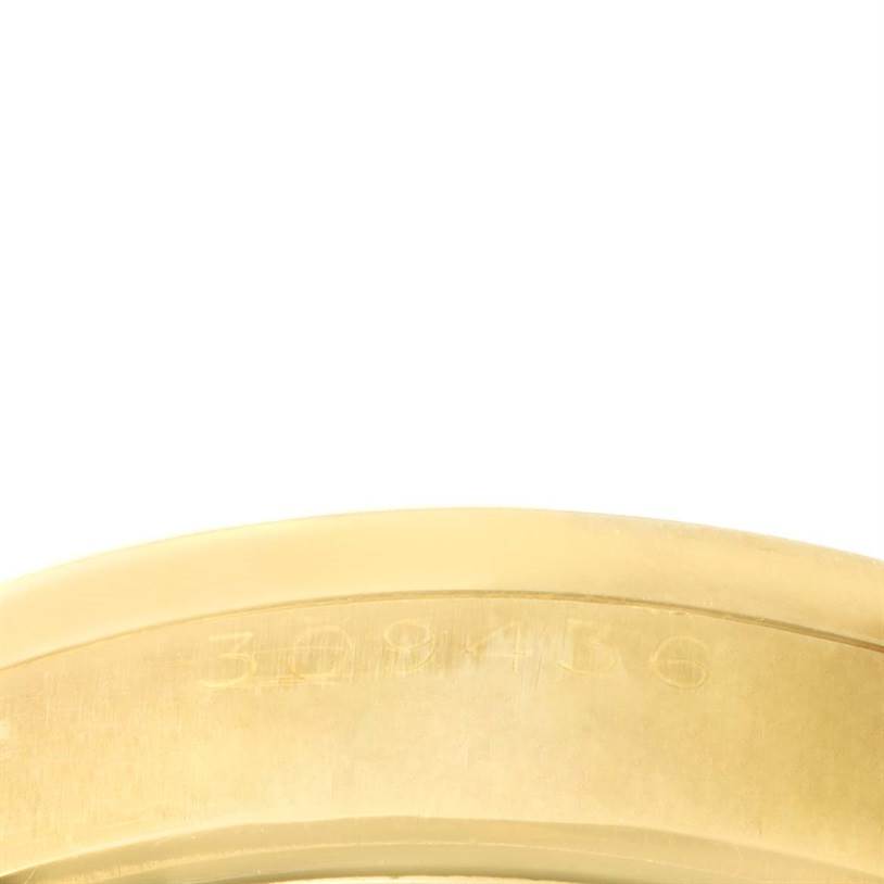 This image shows the engraved serial numbers on the inner side of the bezel of a Rolex Vintage Collection 6569 Men's Yellow Gold Brown Dial 6569 Men's Yellow Gold Brown Dial watch.