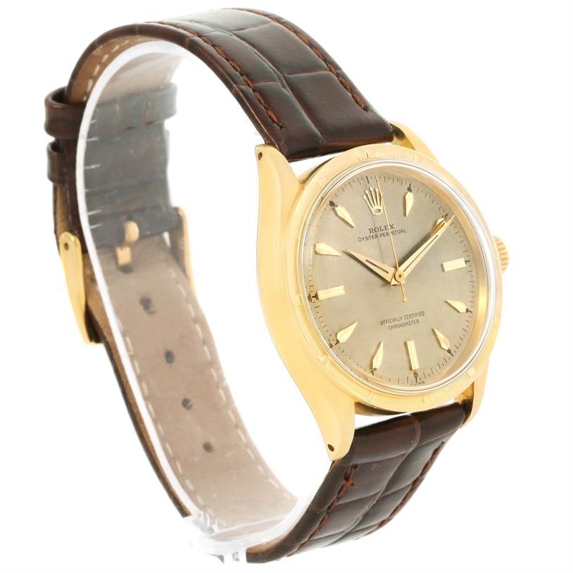 This image shows a side view of the Rolex Vintage Collection 6569 Men's Yellow Gold Brown Dial 6569 Men's Yellow Gold Brown Dial model watch, highlighting the gold case, dial, crown, and leather strap.