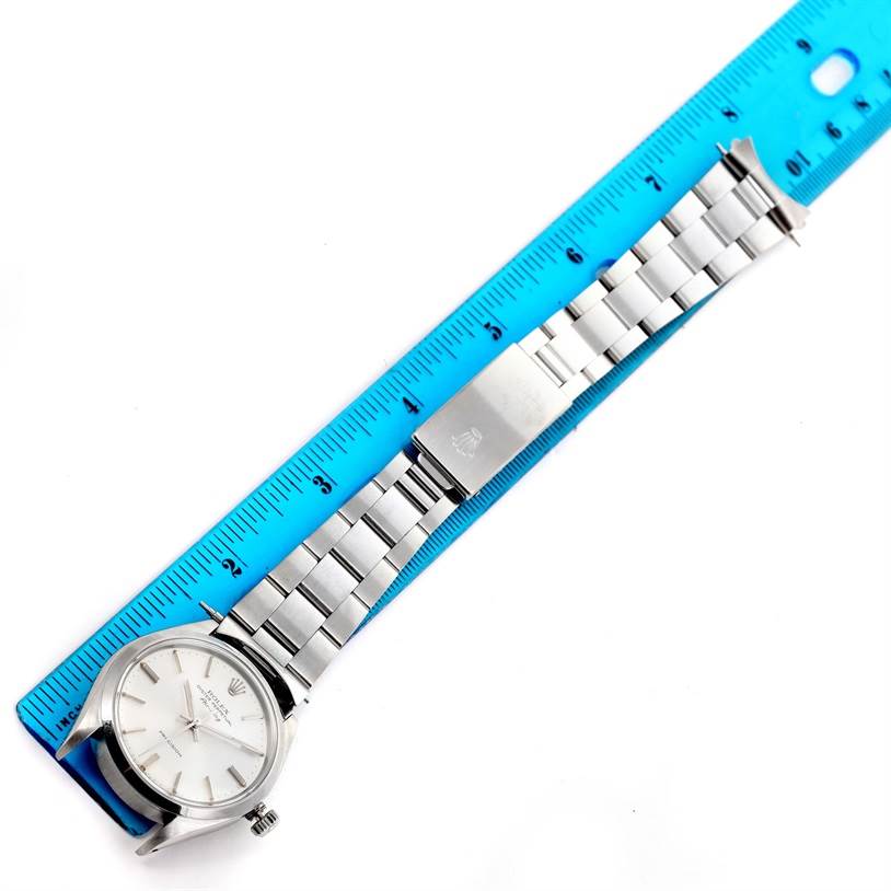 The image shows the face, bracelet, and clasp of a Rolex Vintage Collection 5500 Men's Stainless Steel Silver Dial 5500 Men's Stainless Steel Silver Dial watch measured against a blue ruler.