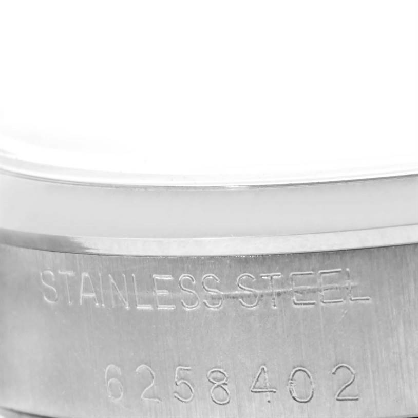 This image shows a close-up of the serial number and "STAINLESS STEEL" engraving on the side of a Rolex Vintage Collection 5500 Men's Stainless Steel Silver Dial 5500 Men's Stainless Steel Silver Dial watch.