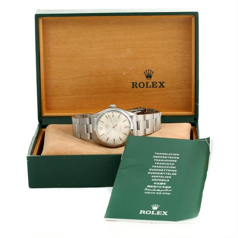 The image shows a Rolex Vintage Collection 5500 Men's Stainless Steel Silver Dial 5500 Men's Stainless Steel Silver Dial watch in its box at a front angle, along with its manual placed beside the box.