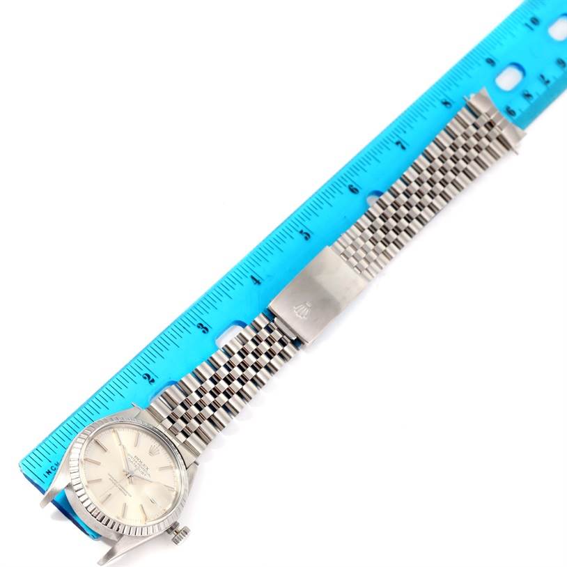 The Rolex Vintage Collection 16030 Men's Stainless Steel Silver Dial 16030 Men's Stainless Steel Silver Dial watch is shown from a top-down angle with its face, bezel, crown, and bracelet displayed against a ruler.