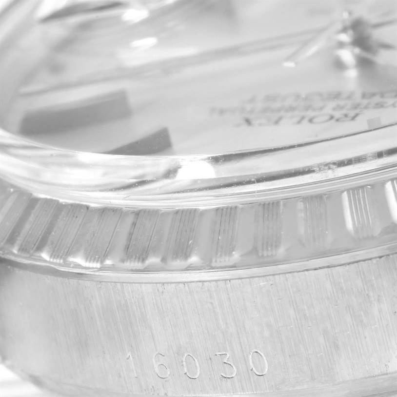 The image shows a close-up side angle of the dial, bezel, and serial number on the case of a Vintage Collection Rolex watch.