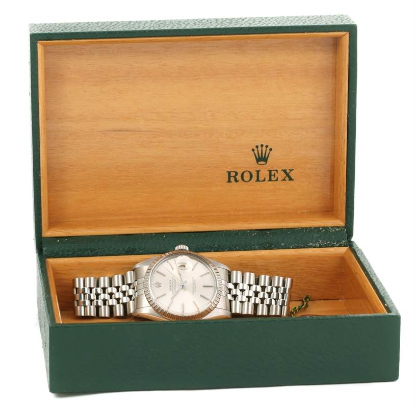 The Rolex Vintage Collection 16030 Men's Stainless Steel Silver Dial 16030 Men's Stainless Steel Silver Dial watch is shown in an open green and wooden box, displaying its face and metal band.