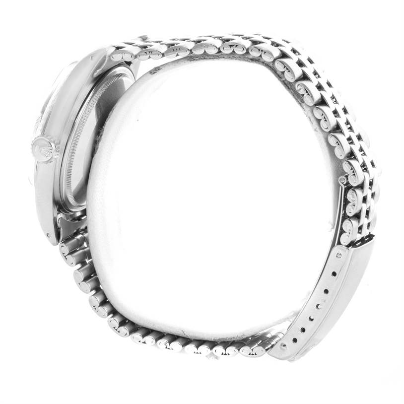 The image shows a side view of a Rolex Vintage Collection 1601 Men's Stainless Steel Silver Dial 1601 Men's Stainless Steel Silver Dial watch, highlighting its case, crown, and bracelet.