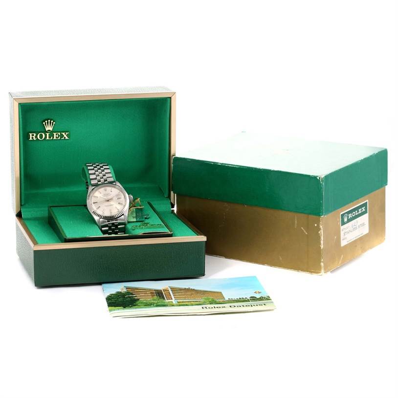 The Vintage Collection Rolex watch is shown at an angle with its box, outer packaging, and booklet.