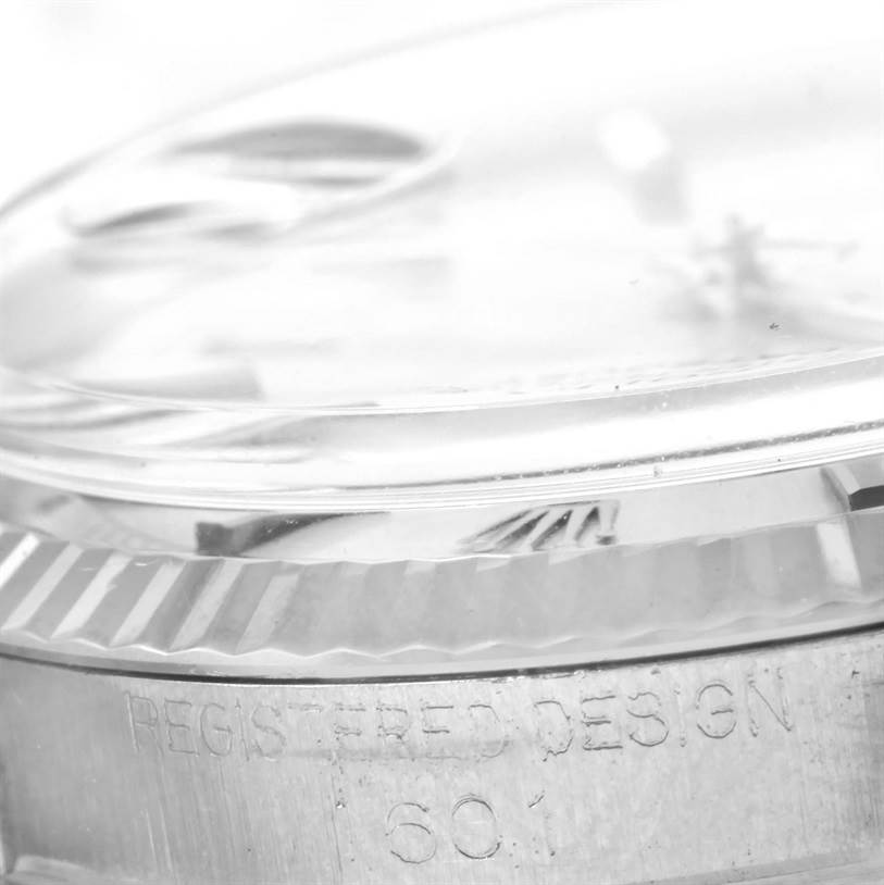 The image shows a close-up of the side view of a Rolex Vintage Collection 1601 Men's Stainless Steel Silver Dial 1601 Men's Stainless Steel Silver Dial watch, focusing on the bezel and part of the crystal.