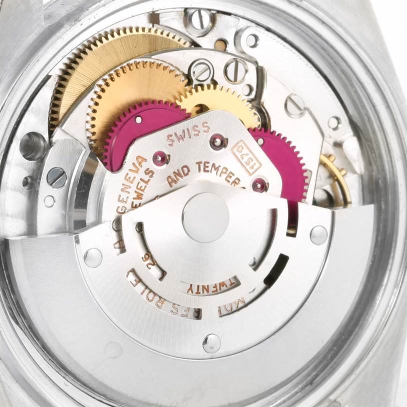 The image shows an up-close view of the movement and internal gears of a Vintage Collection Rolex watch.