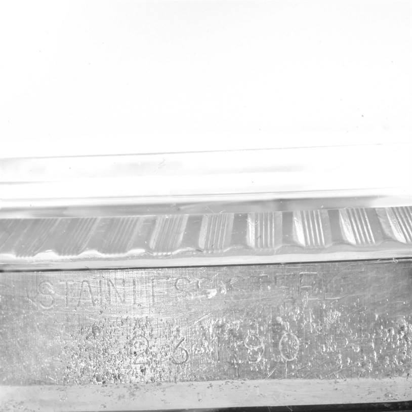 The image shows a close-up of the side case and serial engraving on a Vintage Collection Rolex watch.