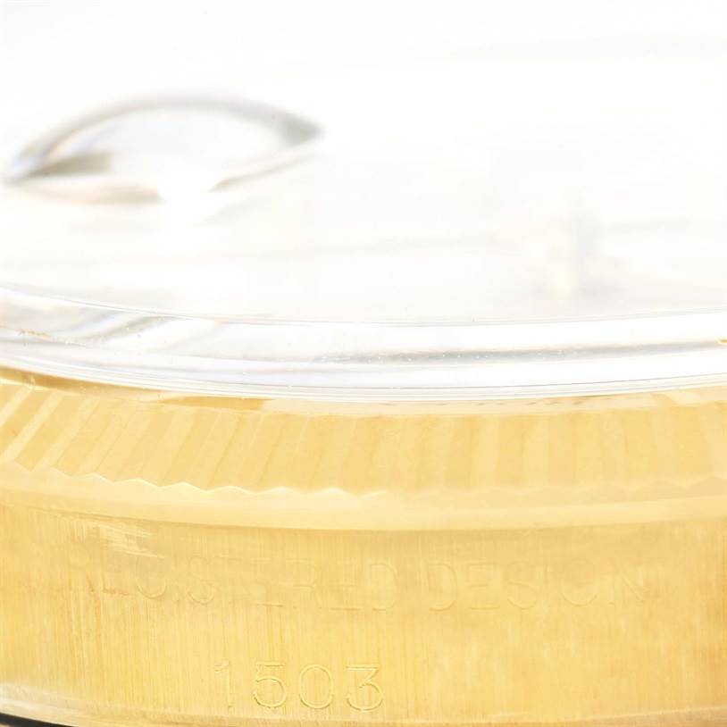 A close-up side view of the Rolex Vintage Collection 1503 Men's Yellow Gold Silver Dial 1503 Men's Yellow Gold Silver Dial model showing its bezel and part of the crystal.