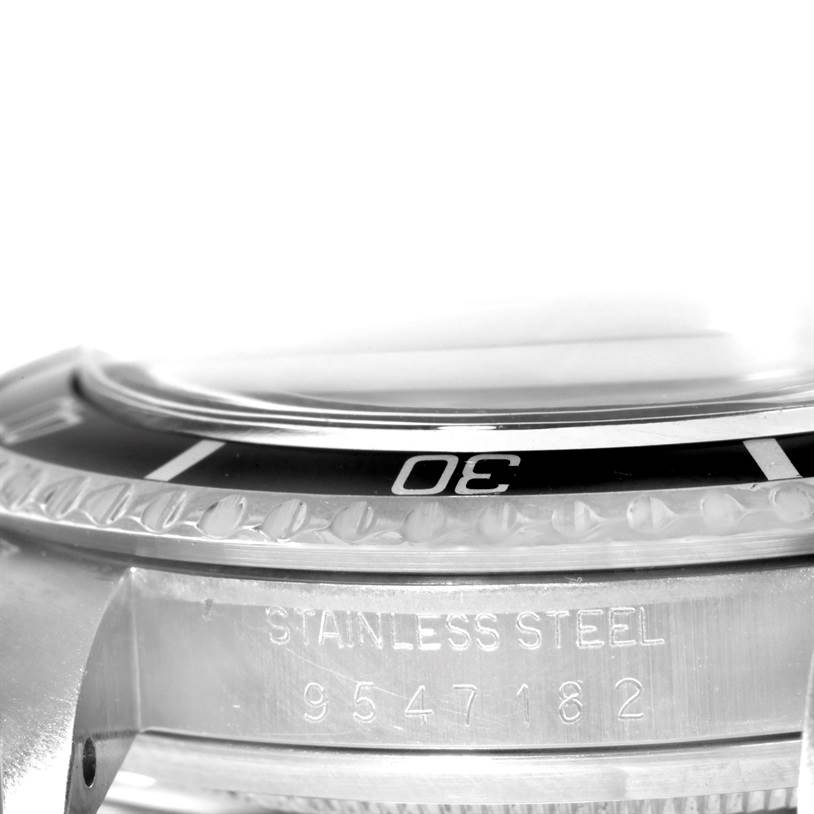 This image shows a close-up angle of the bezel and part of the case of a Rolex Vintage Collection 5513 Men's Stainless Steel Black Dial 5513 Men's Stainless Steel Black Dial watch, highlighting the "30" marker and the stainless steel inscription with the serial number.