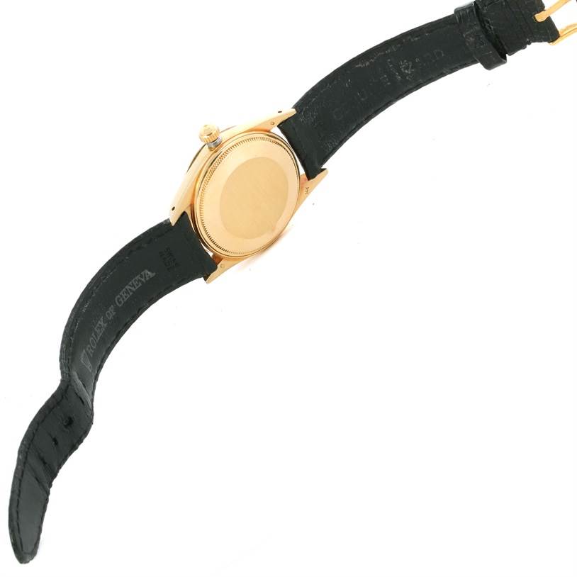 The image shows the back case and leather strap of a Vintage Collection Rolex watch viewed from an underside angle.