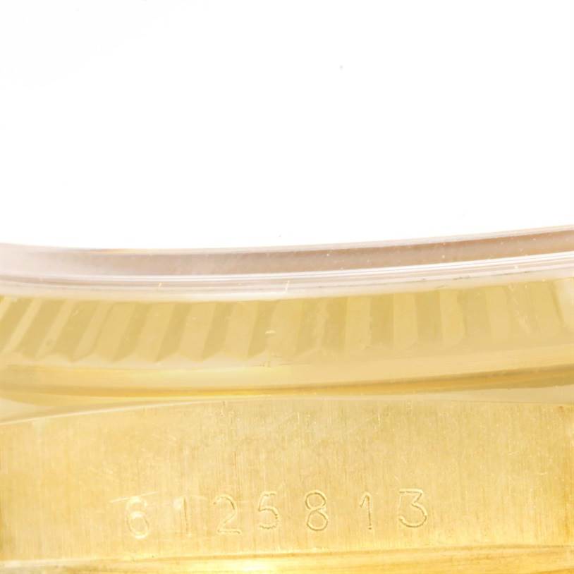 Close-up of the side of a Rolex Vintage Collection 16018 Men's Yellow Gold Champagne Dial 16018 Men's Yellow Gold Champagne Dial watch showing the model number engraving in the gold casing.