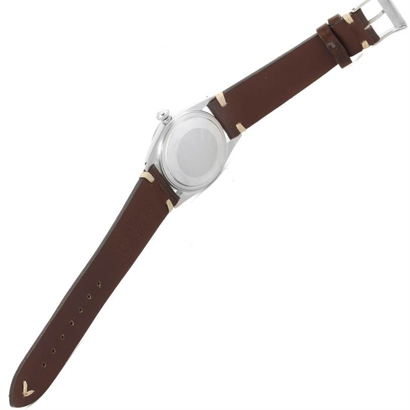 The image shows the back view of a Rolex Vintage Collection 16030 Men's Stainless Steel Silver Dial 16030 Men's Stainless Steel Silver Dial watch featuring a brown leather strap and a closed case back.