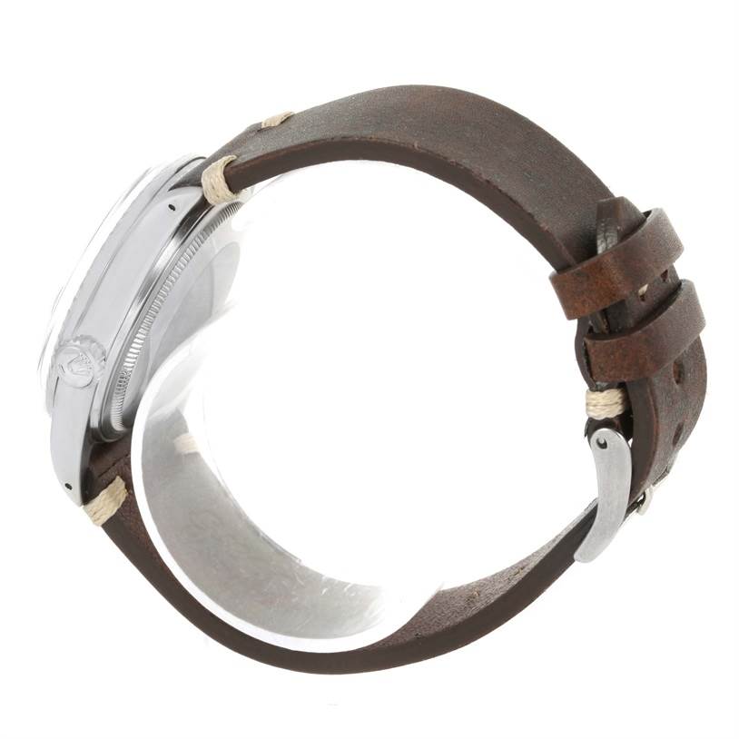 This image shows a side view of the Rolex Vintage Collection 16030 Men's Stainless Steel Silver Dial 16030 Men's Stainless Steel Silver Dial watch, highlighting its case, crown, and brown leather strap.