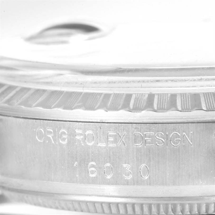 The image shows a close-up of the side engraving and edge of the bezel of a Vintage Collection watch by Rolex, model 16030.