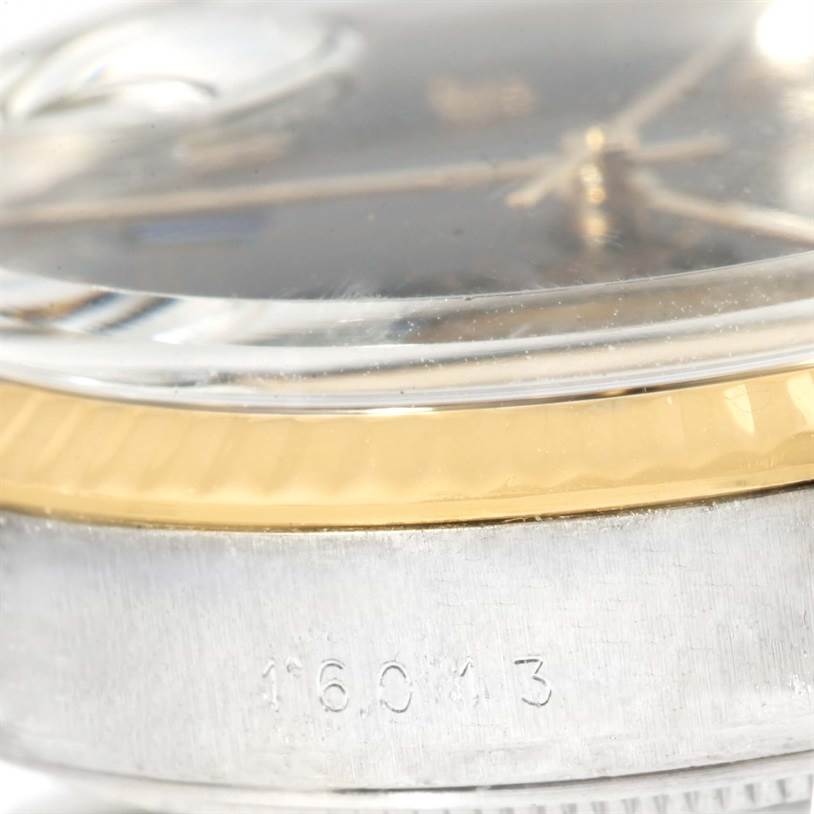 This close-up image of the Vintage Collection Rolex watch shows the bezel, part of the crystal, and the case with model number 16013.