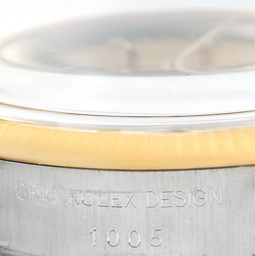 The image shows a close-up side angle of the case and bezel of a Rolex Vintage Collection 1005 Men's Steel and Gold (two tone) Champagne Dial 1005 Men's Steel and Gold (two tone) Champagne Dial model watch, highlighting the engraved model number "1005."