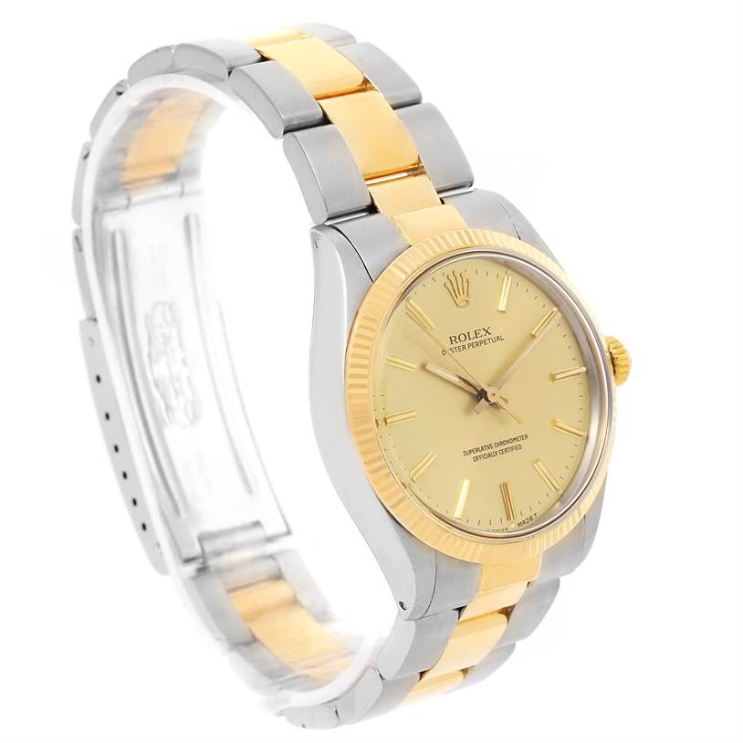 The image shows a diagonal view of a Rolex Vintage Collection 1005 Men's Steel and Gold (two tone) Champagne Dial 1005 Men's Steel and Gold (two tone) Champagne Dial watch, showcasing its gold and silver band, dial, and bezel.