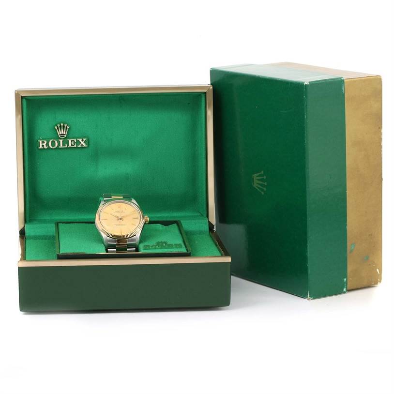 The image shows a Rolex Vintage Collection 1005 Men's Steel and Gold (two tone) Champagne Dial 1005 Men's Steel and Gold (two tone) Champagne Dial watch placed inside an open green Rolex box with the exterior packaging beside it.
