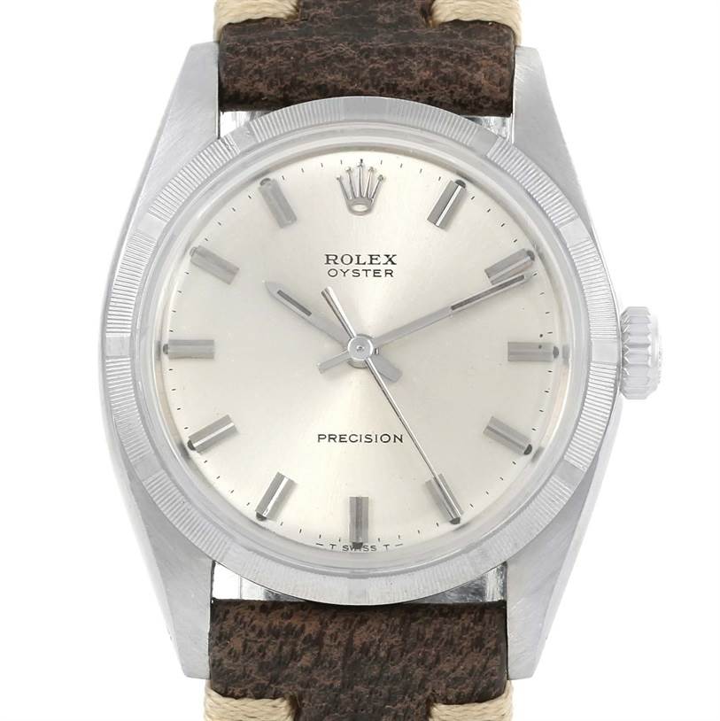 The image shows a front view of a Rolex Vintage Collection 6427 Men's Stainless Steel Silver Dial 6427 Men's Stainless Steel Silver Dial Oyster Precision watch, displaying its dial, bezel, and part of the strap.