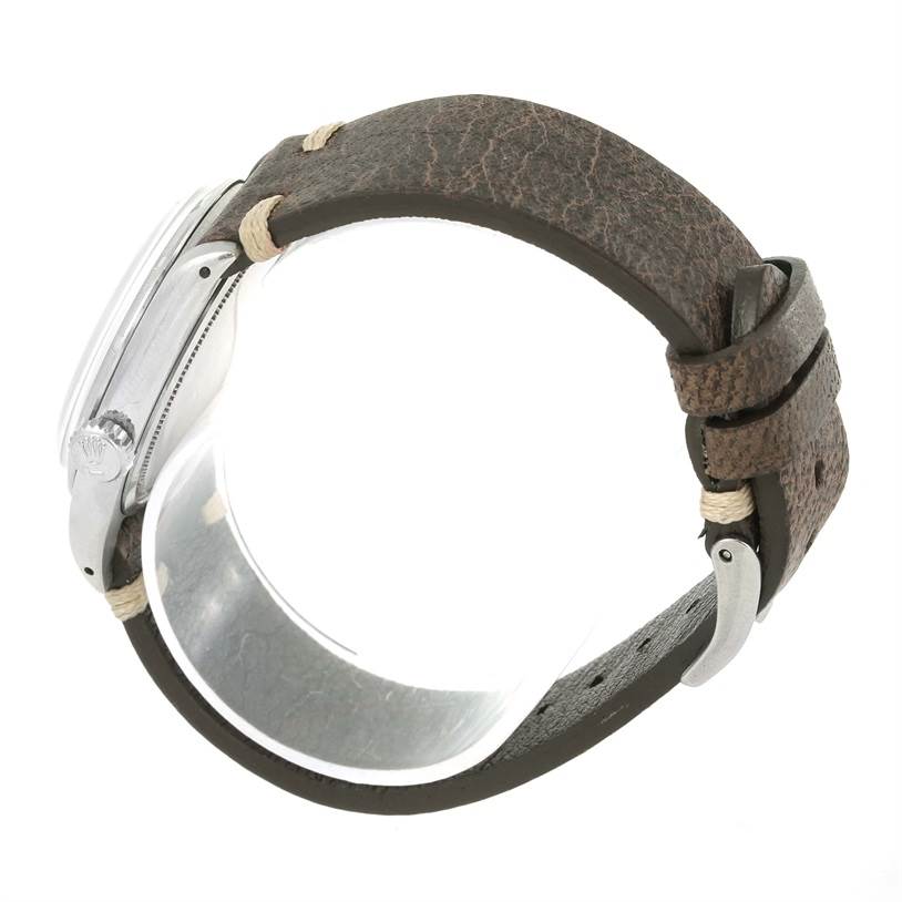 The image shows a side view of the Rolex Vintage Collection 6427 Men's Stainless Steel Silver Dial 6427 Men's Stainless Steel Silver Dial watch, displaying the crown, case, and leather strap.