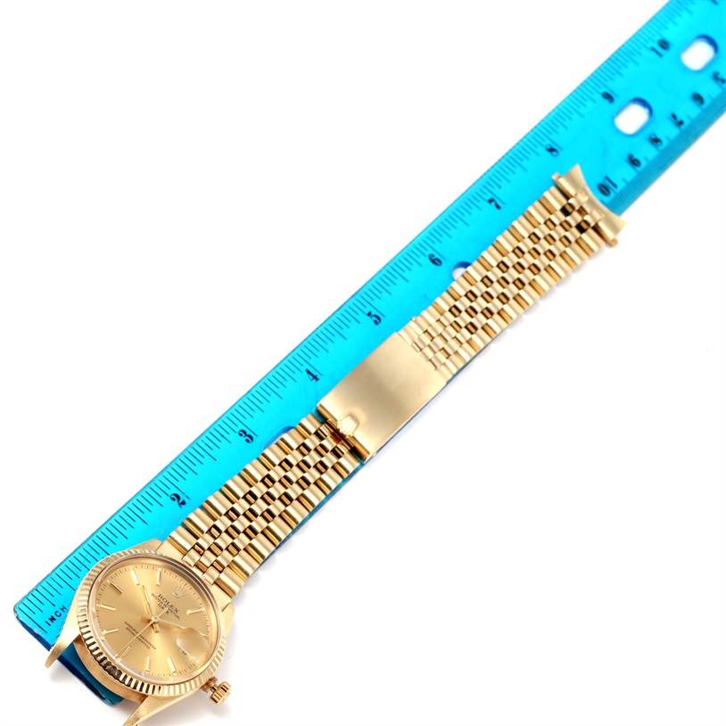 The image shows a laid-out Rolex Vintage Collection 15037 Men's Yellow Gold Champagne Dial 15037 Men's Yellow Gold Champagne Dial watch alongside a ruler for size reference.