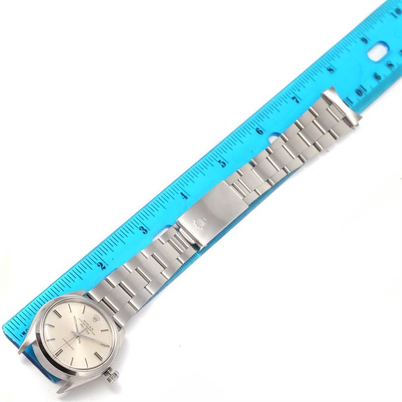 The image shows a Rolex Vintage Collection 5500 Men's Stainless Steel Silver Dial 5500 Men's Stainless Steel Silver Dial watch laid flat, with its entire face and metal bracelet fully visible, placed next to a blue ruler.